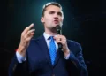 Charlie Kirk speaking at a public event before an audience during his career as a political activist and media personality.