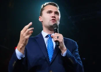 Charlie Kirk speaking at a public event before an audience during his career as a political activist and media personality.