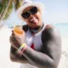 Yermín Mercedes smiling on a beach during vacation, the former MLB player known for his career with the Chicago White Sox.